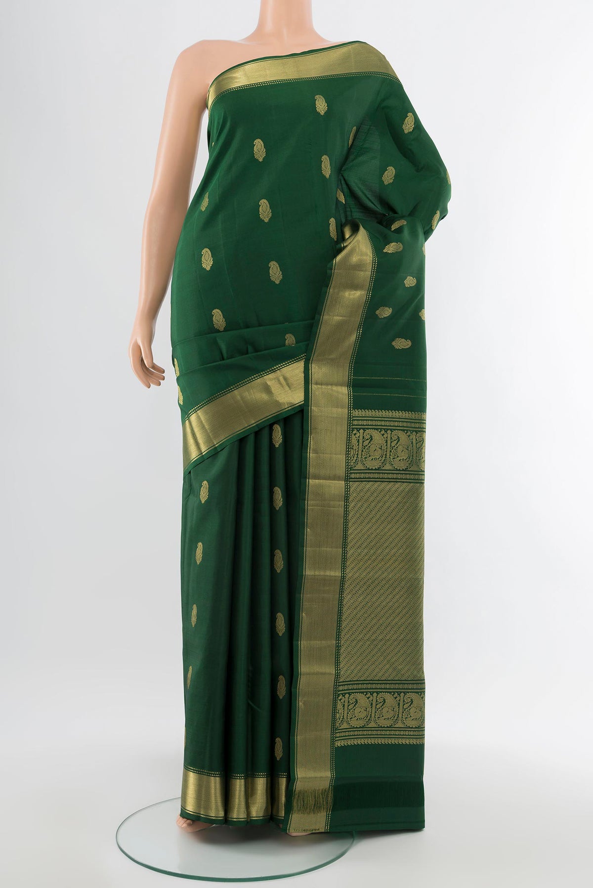 Pure Silk Pure Zari Bottle Green Kanchipuram Saree with Zari Butta on the body and Silk Border.  displayed on a mannequin