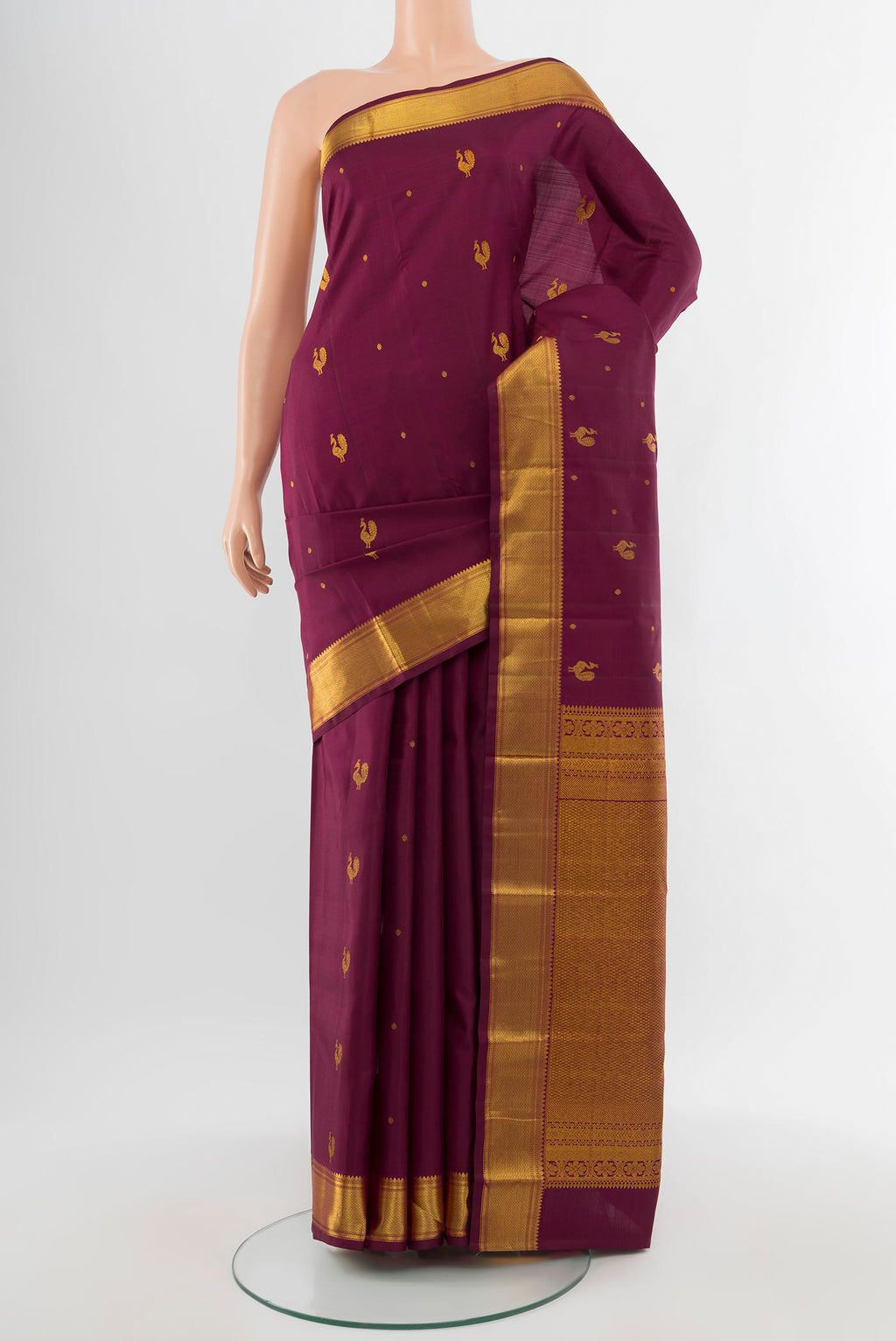 Pure Silk Pure Zari Maroon Kanchipuram Saree with Zari Butta on the body and Silk Border.  displayed on a mannequin