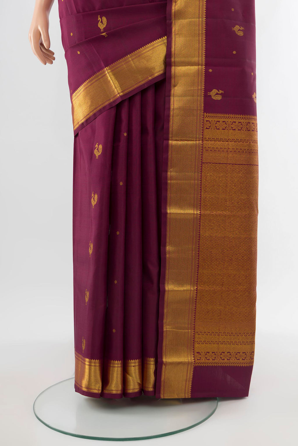 Pleats and pallu of Pure Silk Pure Zari Maroon Kanchipuram Saree with Zari Butta on the body and Silk Border. 