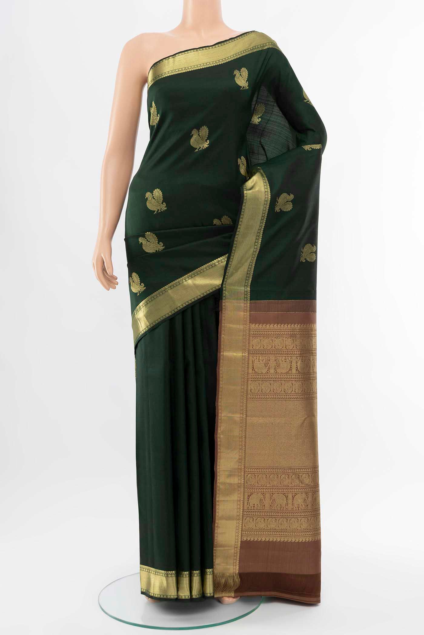 Bottle Green Kanchipuram Silk Saree with Zari Butta on the body and Silk Border displayed on a mannequin