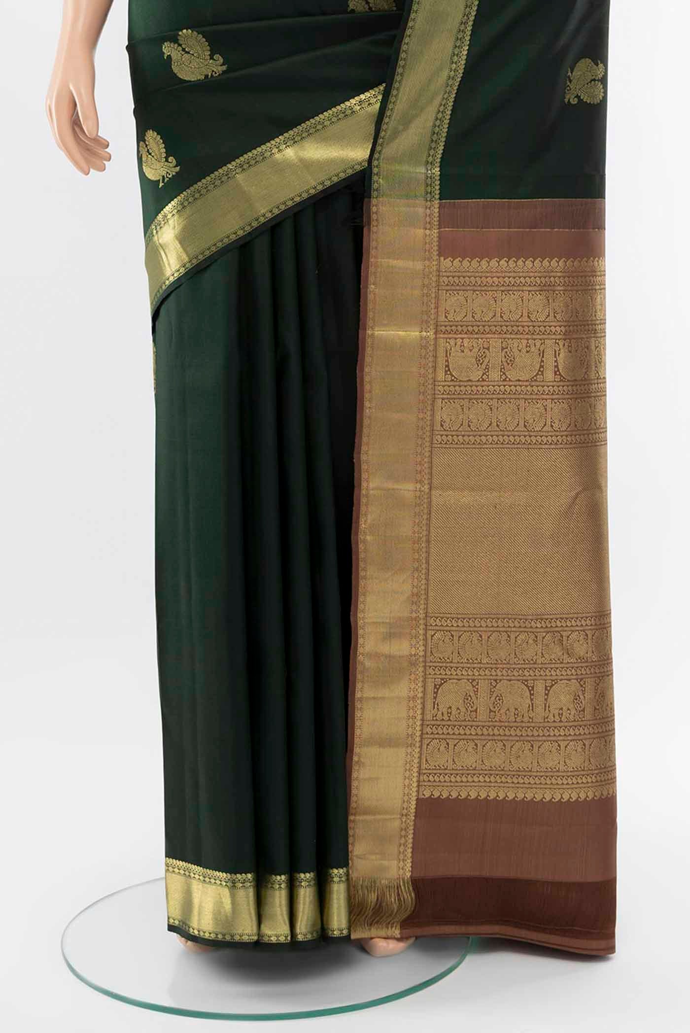 Pleats and pallu of Bottle Green Kanchipuram Silk Saree with Zari Butta on the body and Silk Border