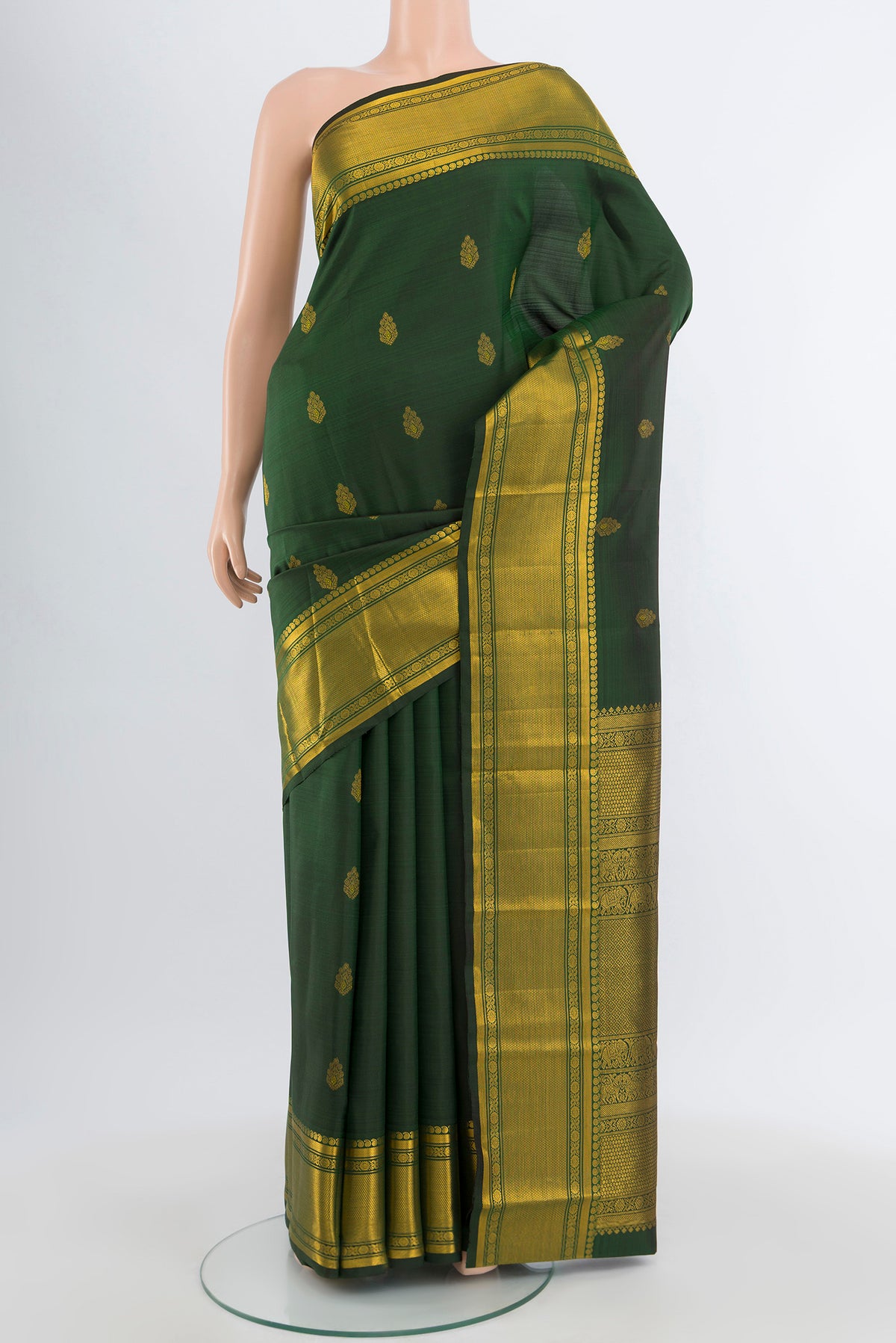 Bottle Green Kanjivaram Silk Saree with Zari Butta on the body and Zari Border.  displayed on a mannequin
