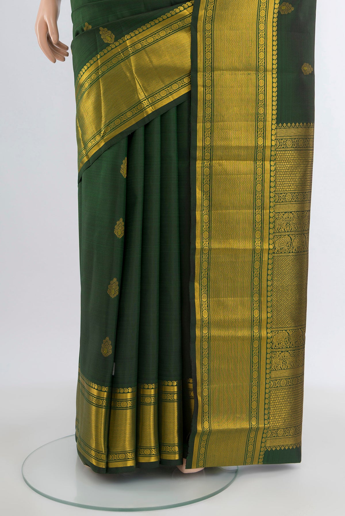 Pleats and pallu of Bottle Green Kanjivaram Silk Saree with Zari Butta on the body and Zari Border. 