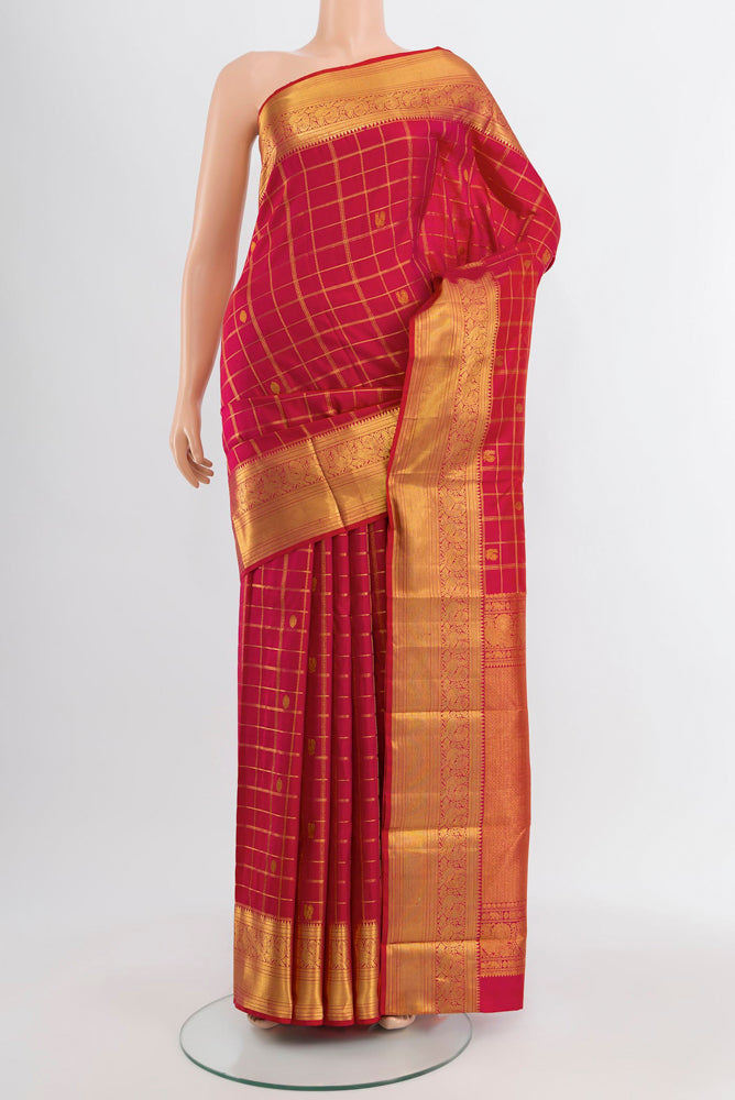 Dark Pink Kanjivaram Silk Saree with Zari Butta on the body and Silk Border.  displayed on a mannequin