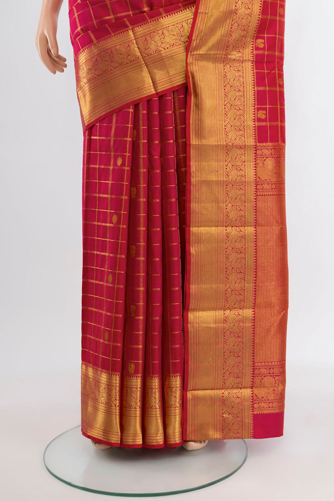 Pleats and pallu of Dark Pink Kanjivaram Silk Saree with Zari Butta on the body and Silk Border. 