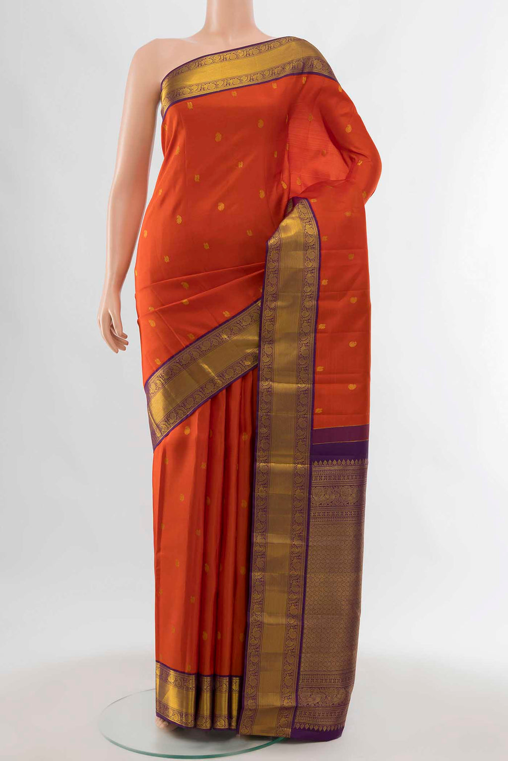 Orange Kanchipuram Silk Saree with Zari Butta on the body and Zari Border displayed on a mannequin