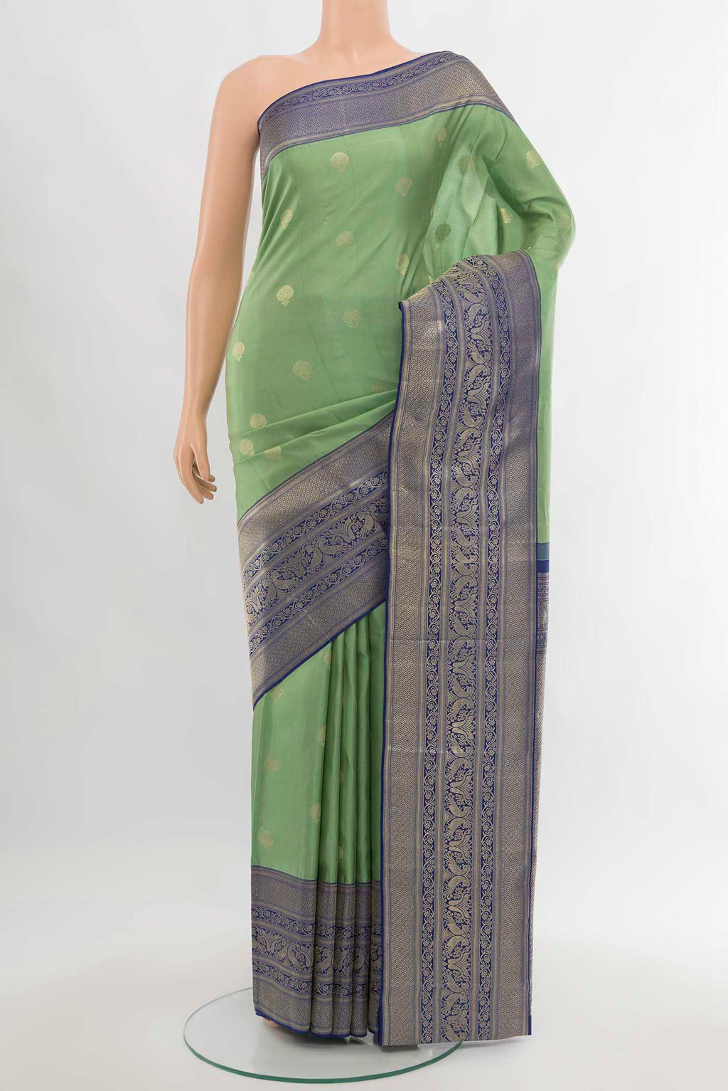 Pista Green Kanjivaram Silk Saree with Zari Butta on the body and Silk Border.  displayed on a mannequin