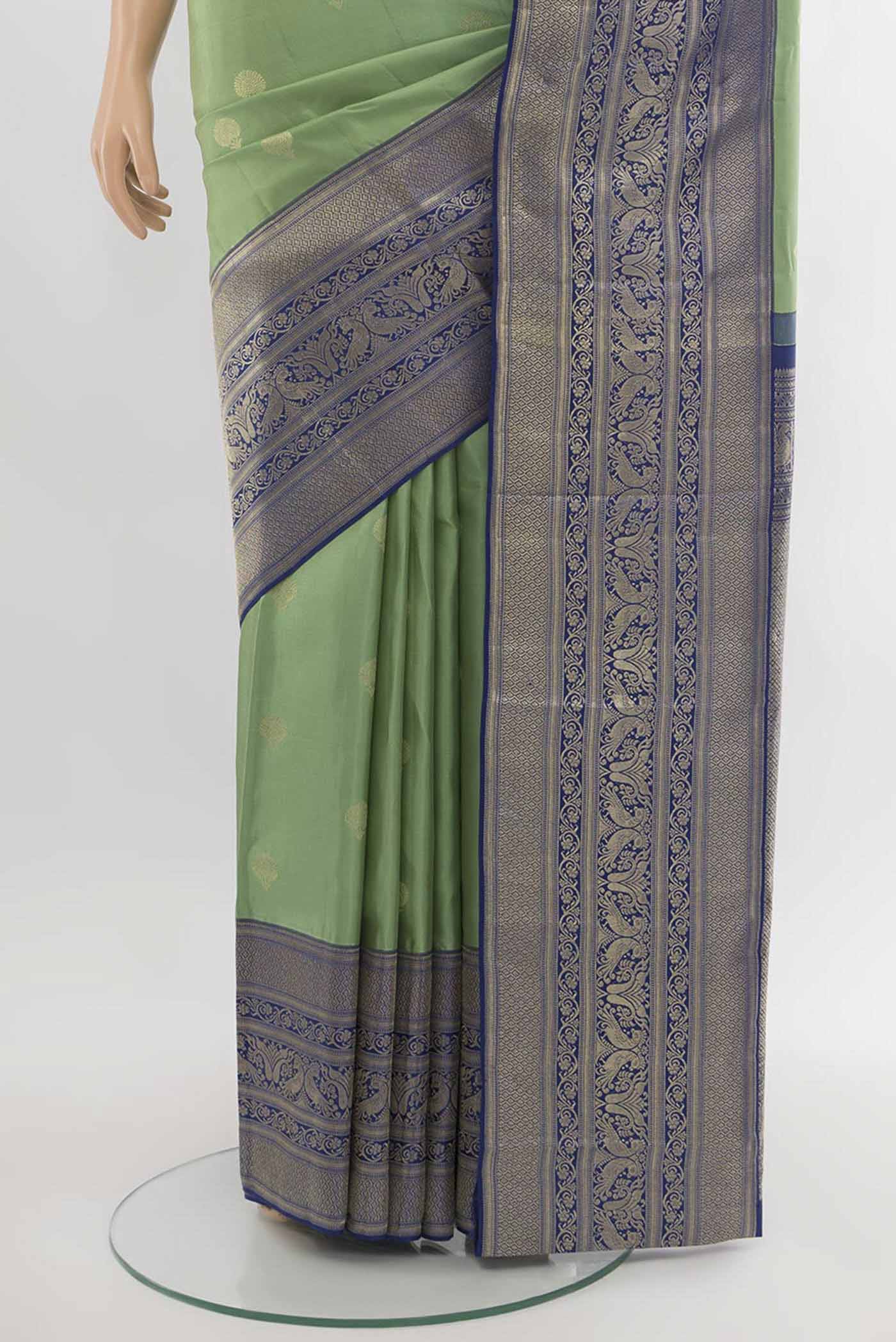 Pleats and pallu of Pista Green Kanjivaram Silk Saree with Zari Butta on the body and Silk Border. 
