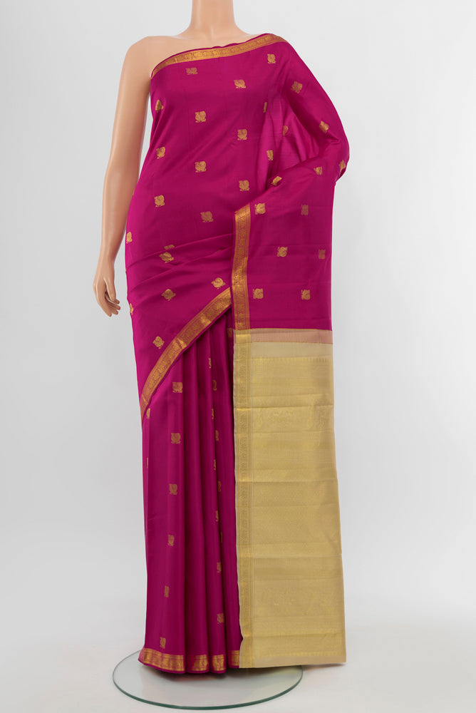 Dark Pink Kanchipuram Silk Saree with Zari Butta on the body and Silk Border.  displayed on a mannequin