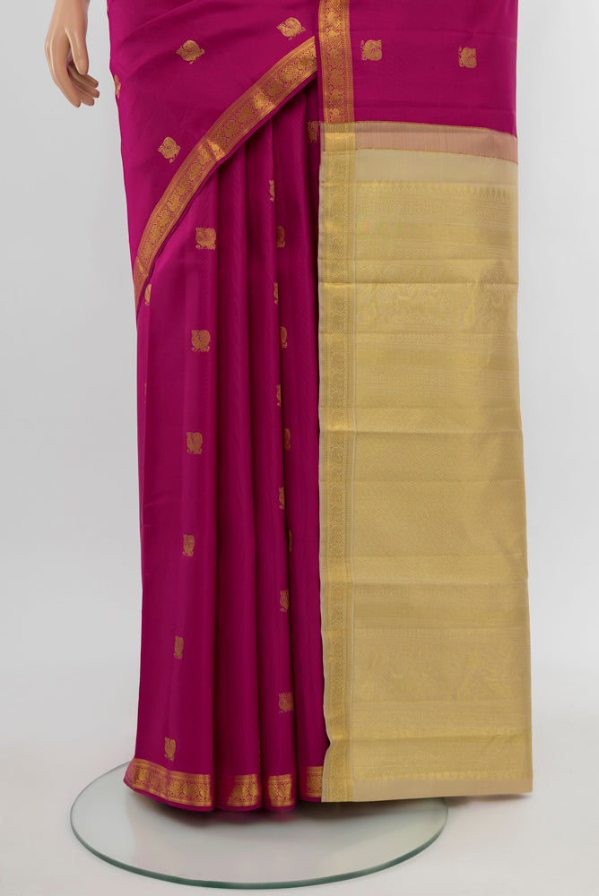 Pleats and pallu of Dark Pink Kanchipuram Silk Saree with Zari Butta on the body and Silk Border. 