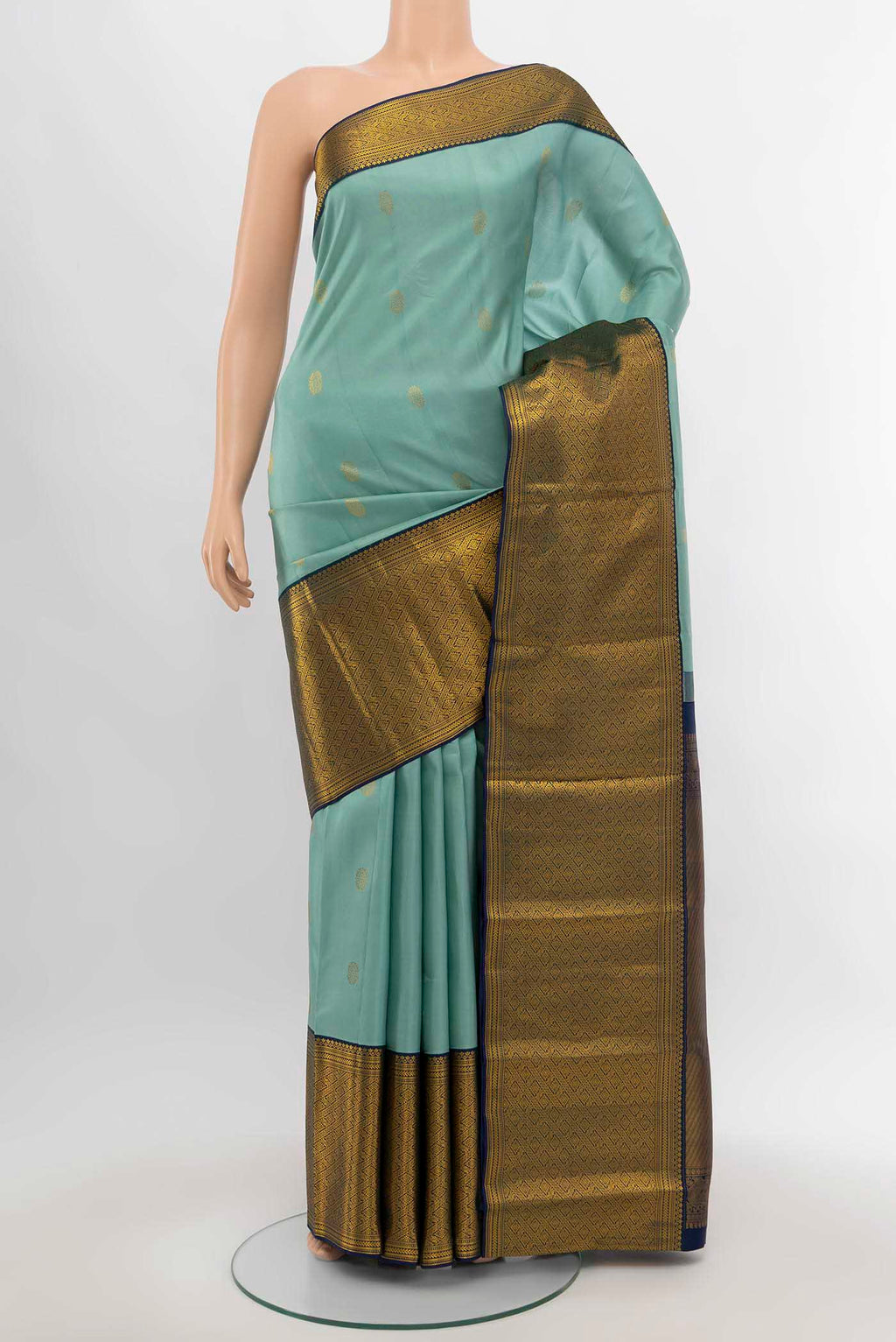 Light Green Kanjivaram Silk Saree with Zari Butta on the body and Silk Border.  displayed on a mannequin