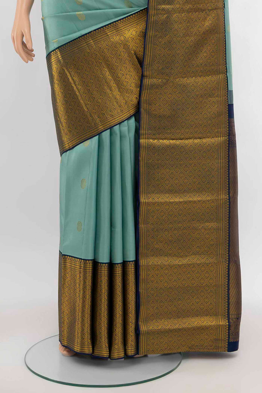 Pleats and pallu of Light Green Kanjivaram Silk Saree with Zari Butta on the body and Silk Border. 