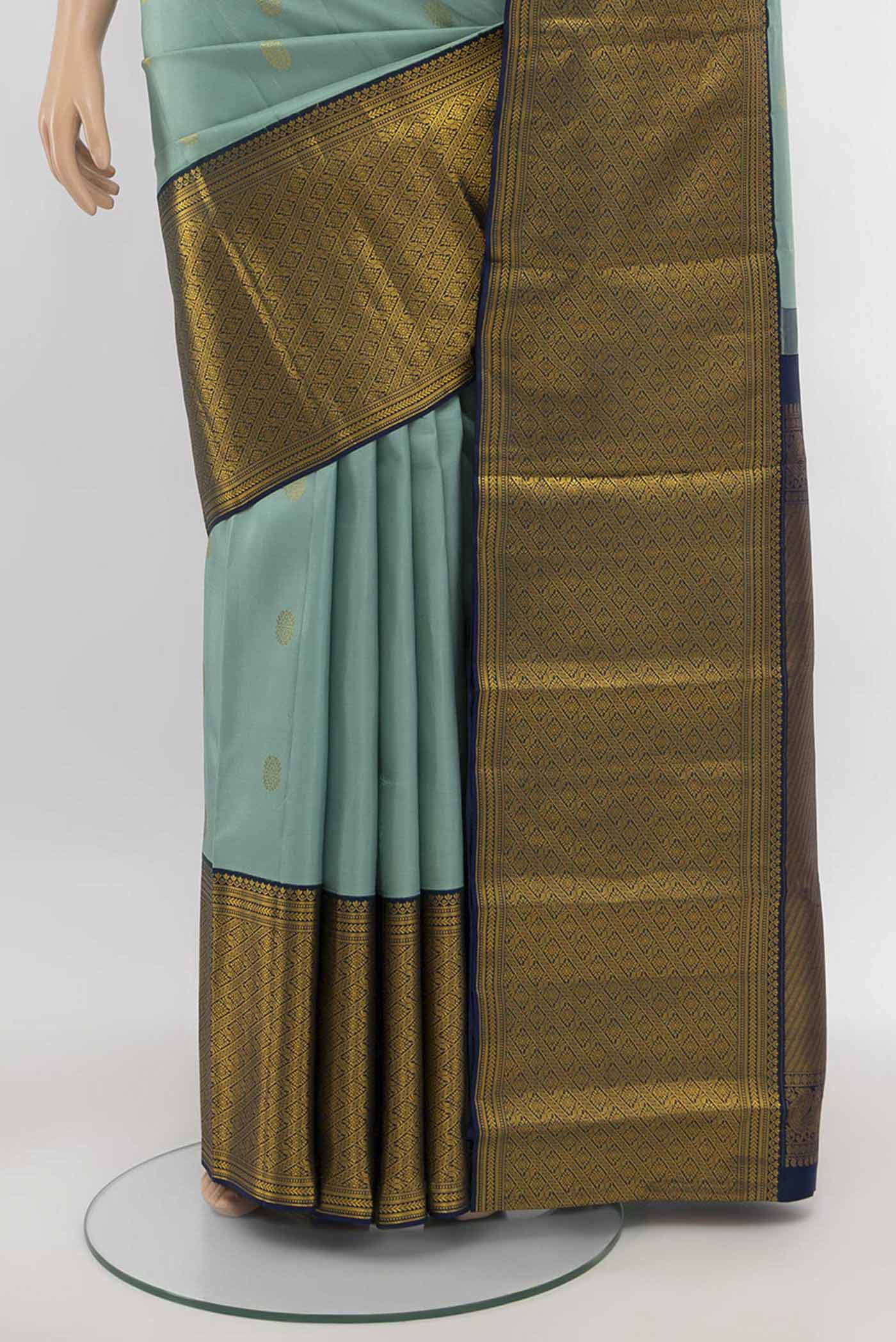 Pleats and pallu of Light Green Kanjivaram Silk Saree with Zari Butta on the body and Silk Border. 