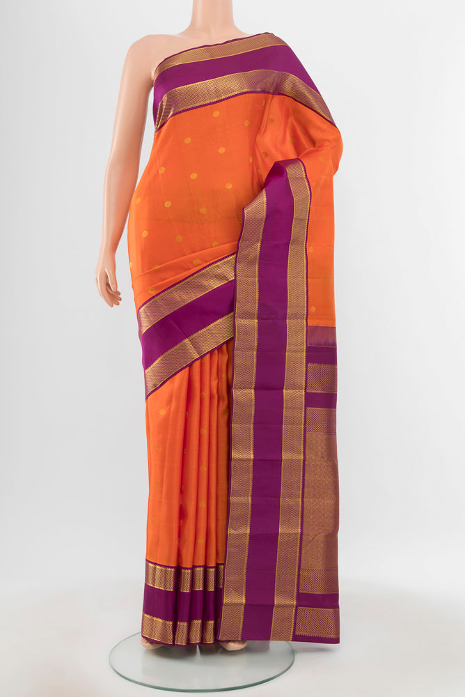 Pure Silk Pure Zari Peach Kanjivaram Saree with Zari Butta on the body and Silk Border.  displayed on a mannequin