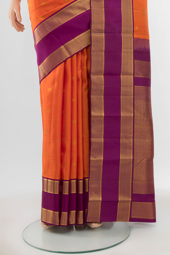 Pleats and pallu of Pure Silk Pure Zari Peach Kanjivaram Saree with Zari Butta on the body and Silk Border. 
