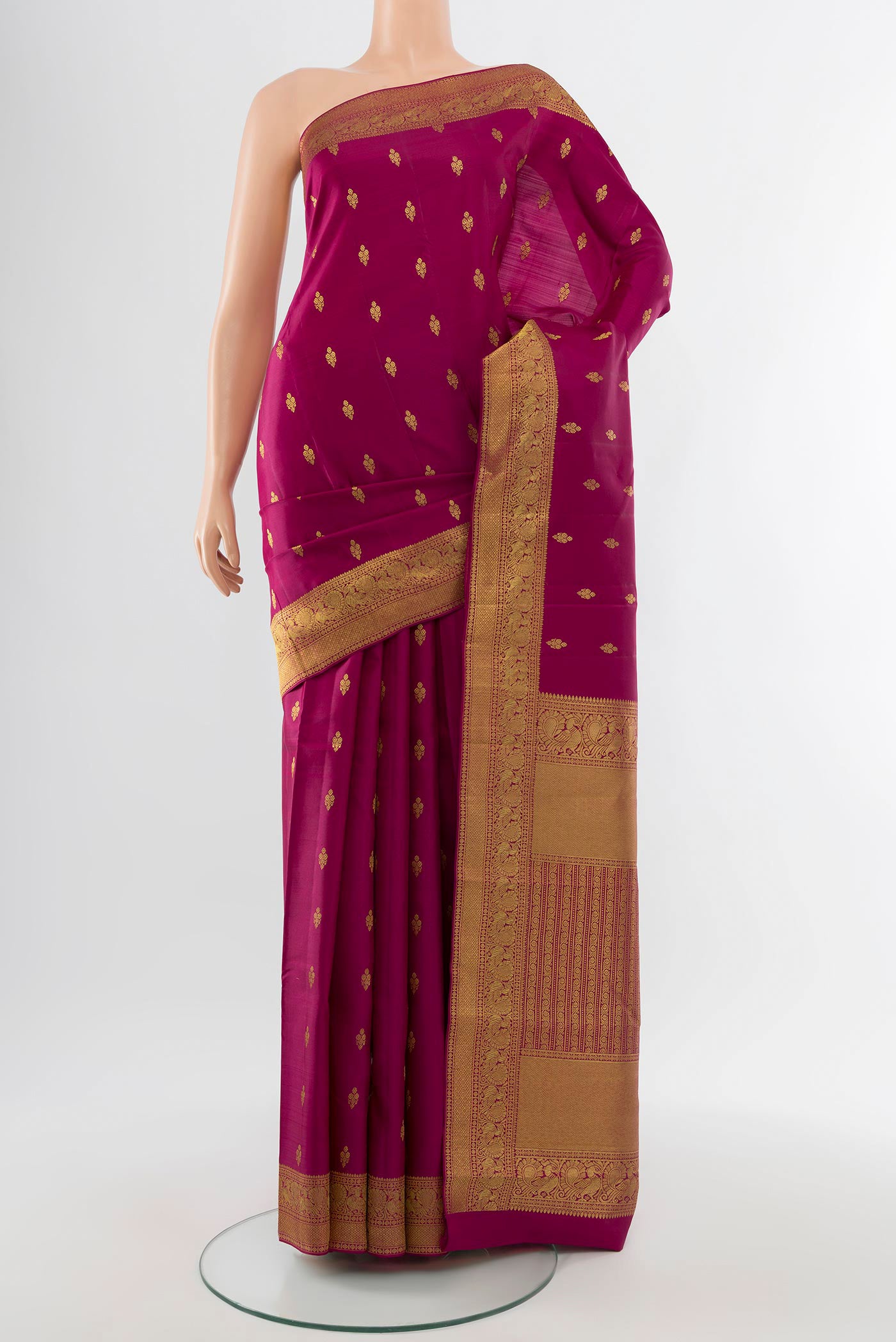 Pure Silk Pure Zari Maroon Kanjivaram Saree with Zari Butta on the body and Silk Border.  displayed on a mannequin