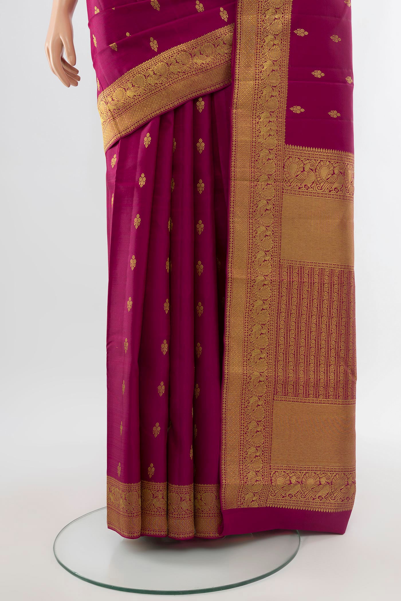 Pleats and pallu of Pure Silk Pure Zari Maroon Kanjivaram Saree with Zari Butta on the body and Silk Border. 