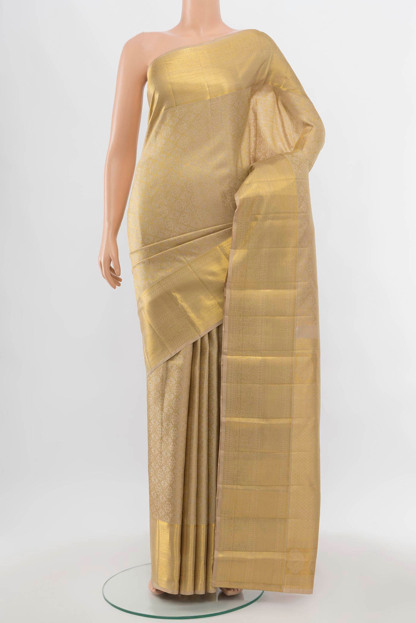 Beige Kanjivaram Silk Saree with Zari Butta on the body and Silk Border.  displayed on a mannequin