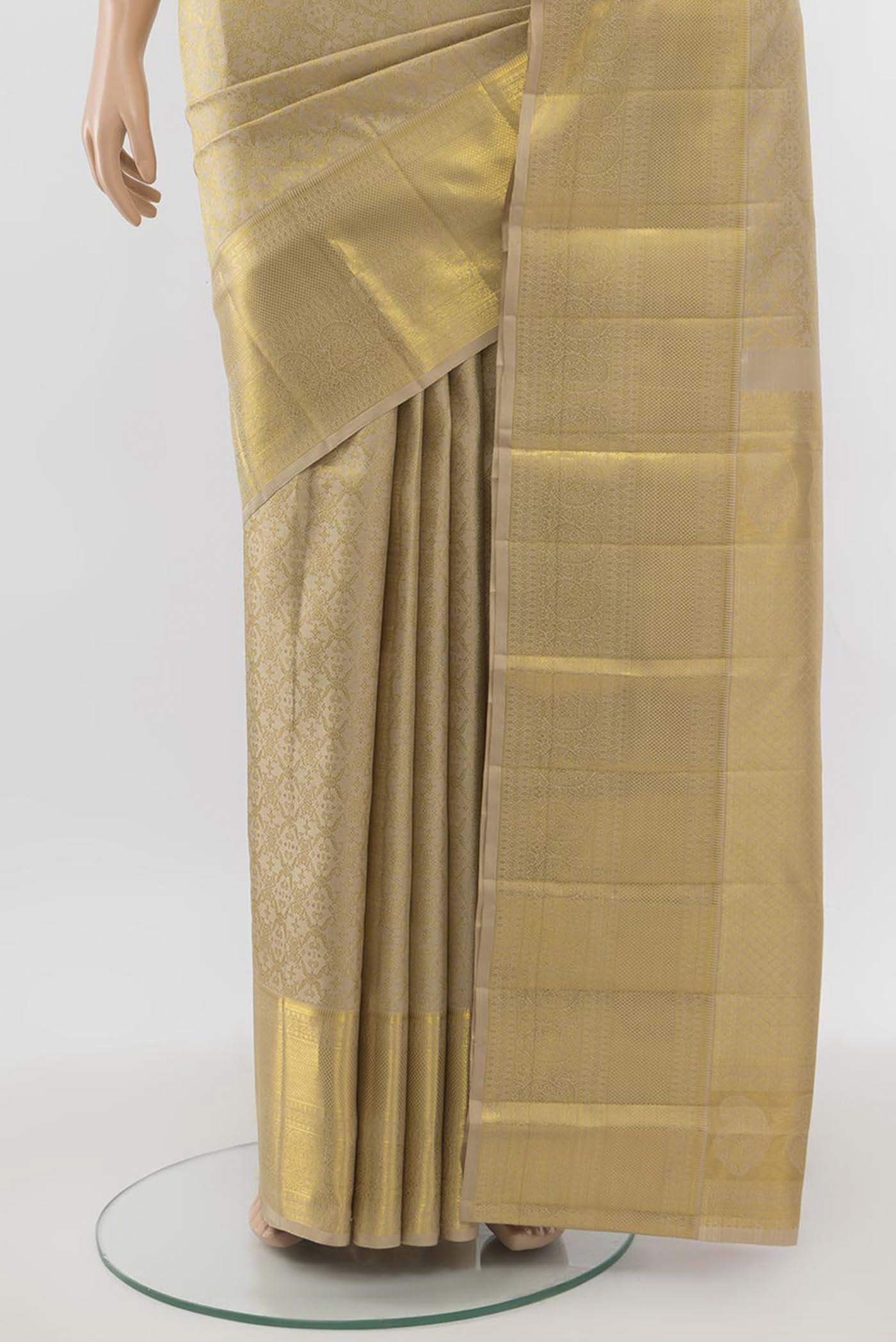 Pleats and pallu of Beige Kanjivaram Silk Saree with Zari Butta on the body and Silk Border. 