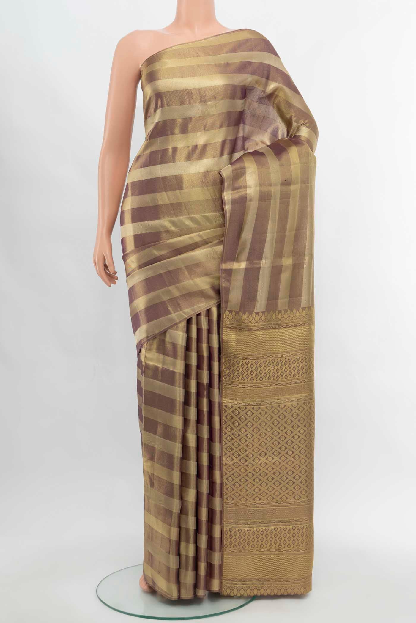 Golden Kanjivaram Silk Saree with Zari Butta on the body and Silk Border.  displayed on a mannequin