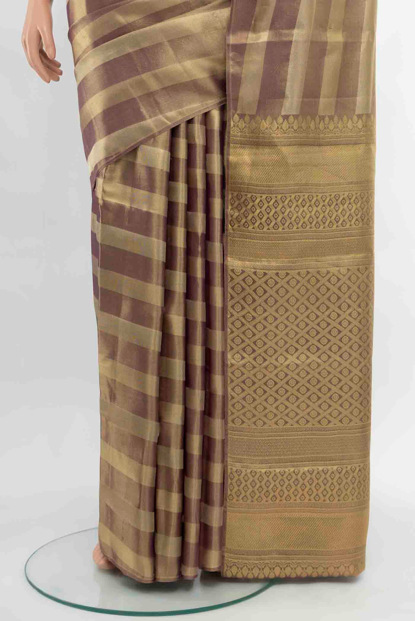 Pleats and pallu of Golden Kanjivaram Silk Saree with Zari Butta on the body and Silk Border. 