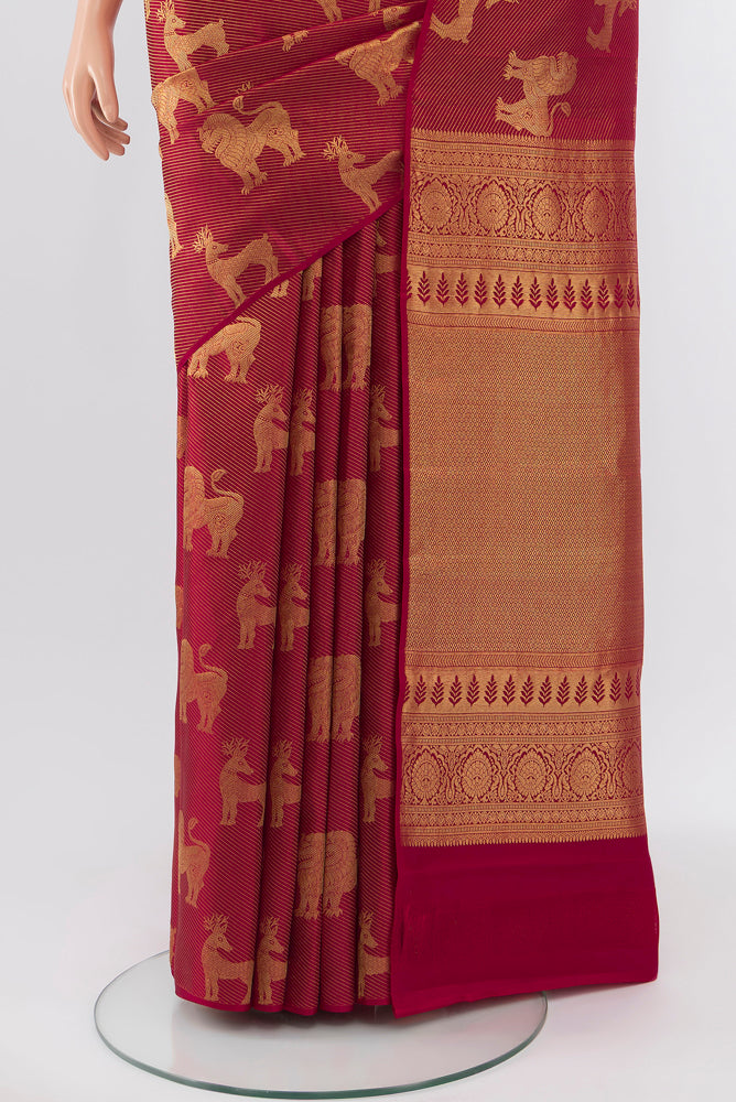 Pleats and pallu of Pure Silk Pure Zari Maroon Kanchipuram Saree with Zari Butta on the body and Silk Border. 