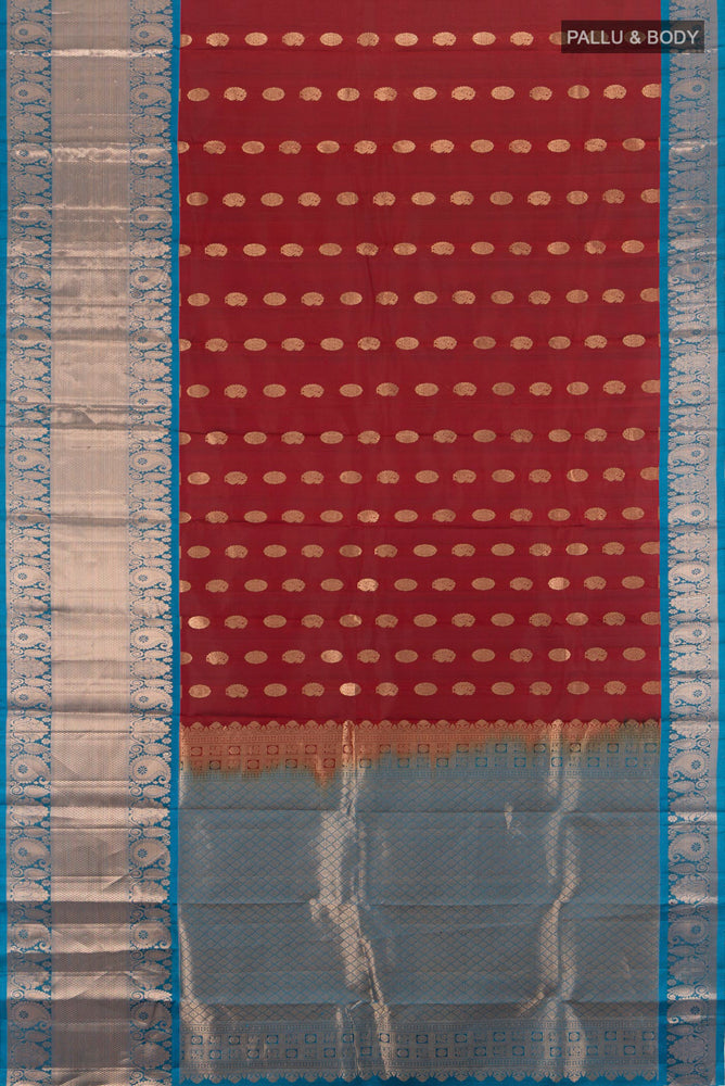 Flat view of Maroon Kanchipuram Silk Saree with Zari Butta on the body and Silk Border. 