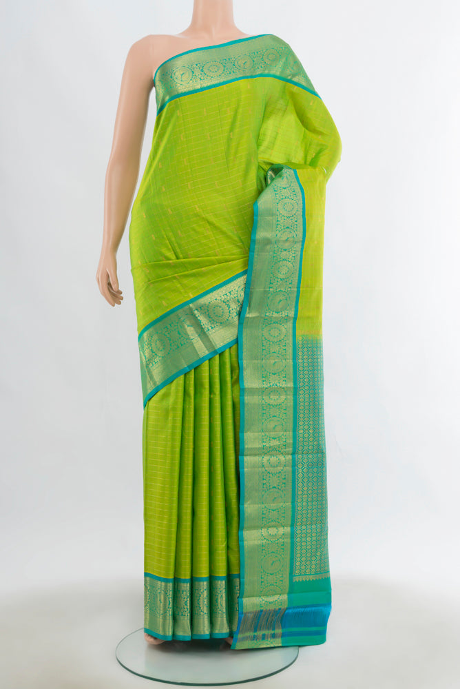 Parrot Green Kanchipuram Silk Saree with Zari Butta on the body and Silk Border.  displayed on a mannequin