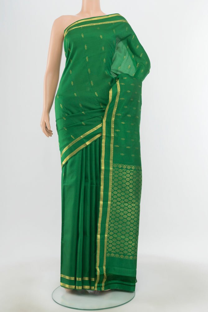 Pure Silk Pure Zari Light Green Kanjivaram Saree with Zari Butta on the body and Silk Border.  displayed on a mannequin