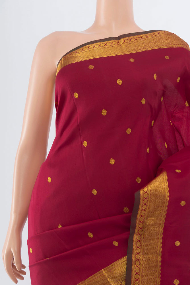 Border image of Maroon Kanchipuram Silk Saree with Zari Butta on the body and Silk Border. 