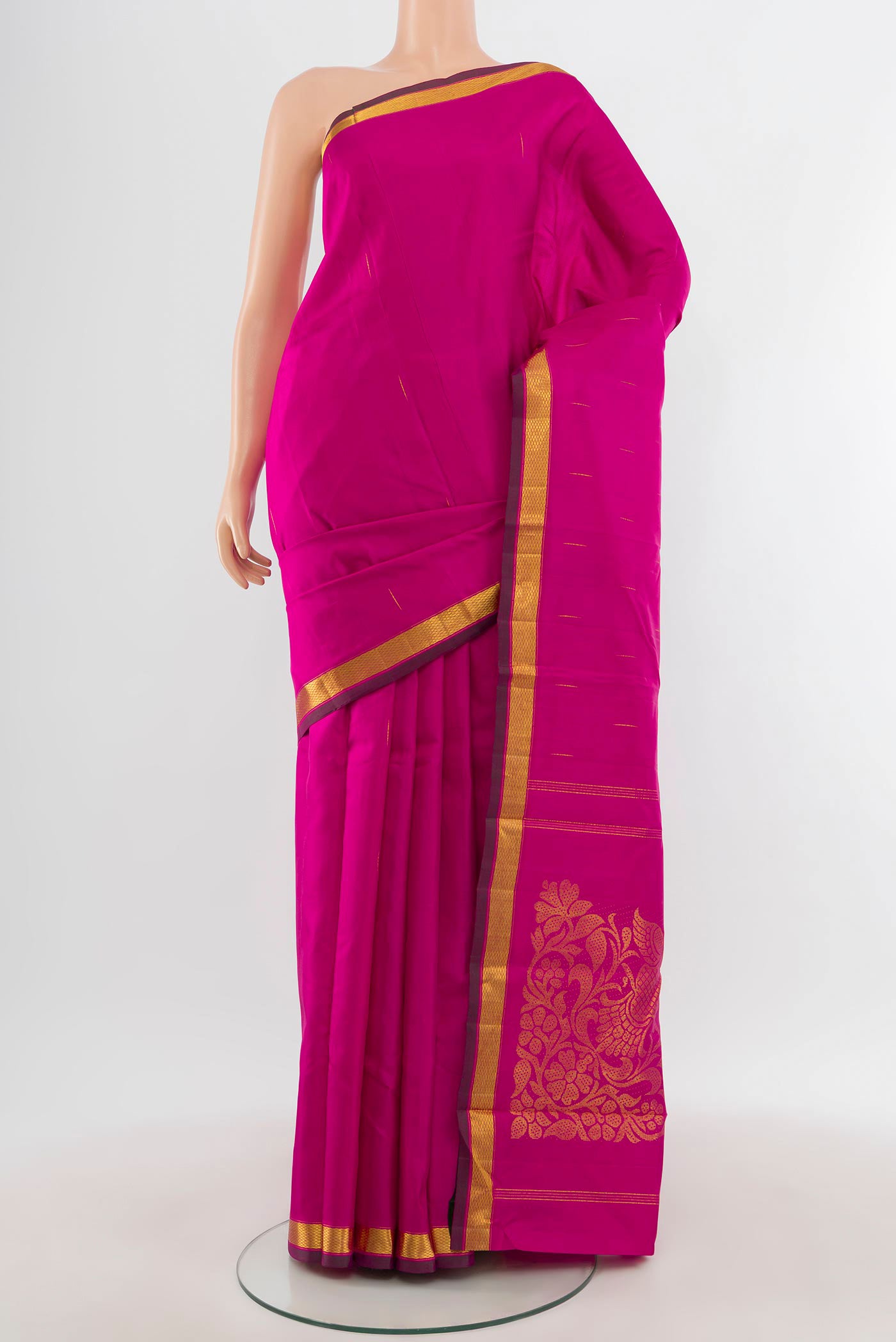 Pure Silk Pure Zari Rani Pink Kanjivaram Saree with Zari Butta on the body and Zari Border.  displayed on a mannequin