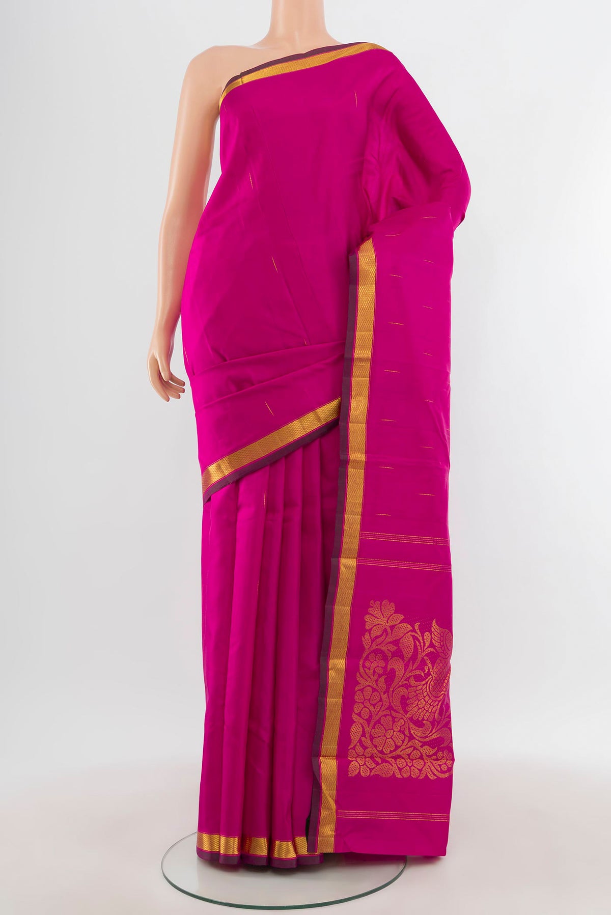 Pure Silk Pure Zari Rani Pink Kanjivaram Saree with Zari Butta on the body and Zari Border.  displayed on a mannequin