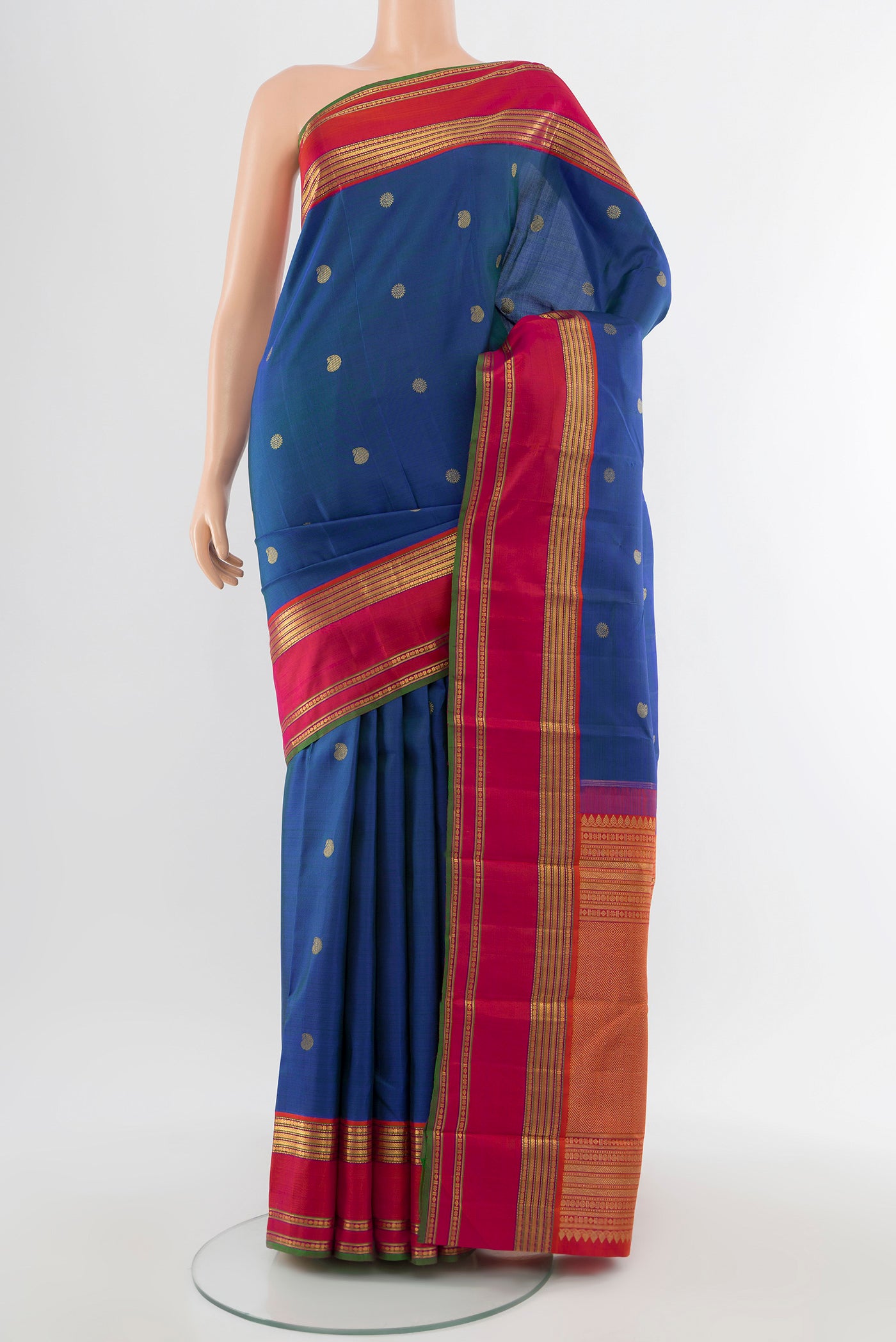 Pure Silk Pure Zari Peacock Blue Kanchipuram Saree with Zari Butta on the body and Silk Border.  displayed on a mannequin