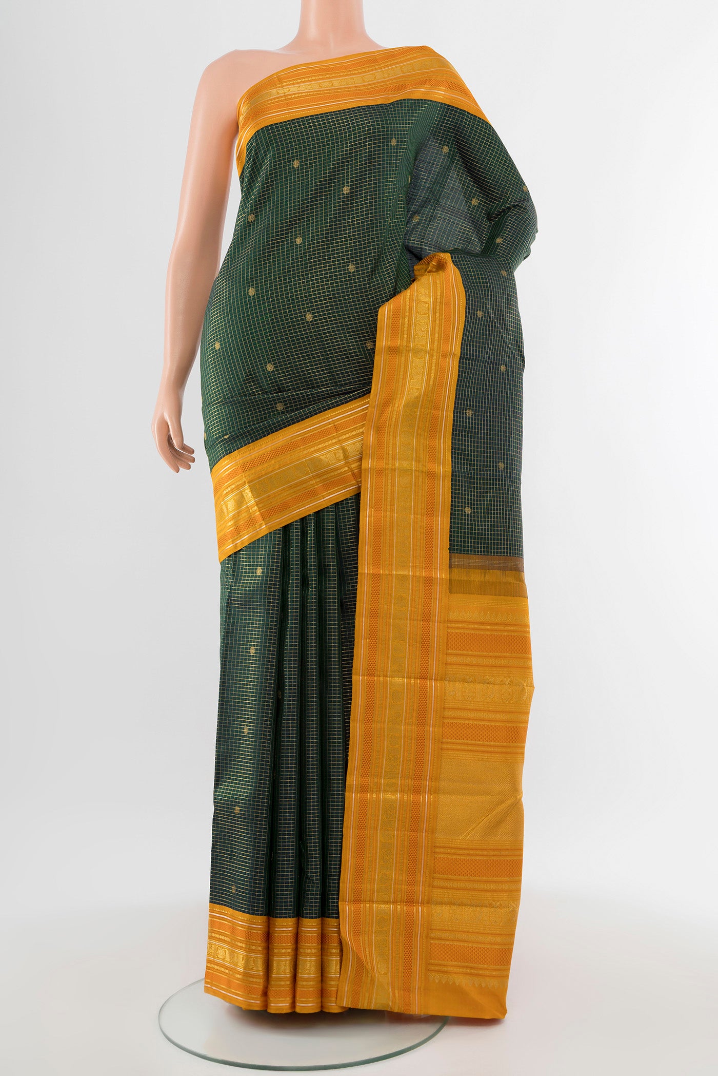 Pure Silk Pure Zari Bottle Green Kanjivaram Saree with Zari Butta on the body and Silk Border.  displayed on a mannequin