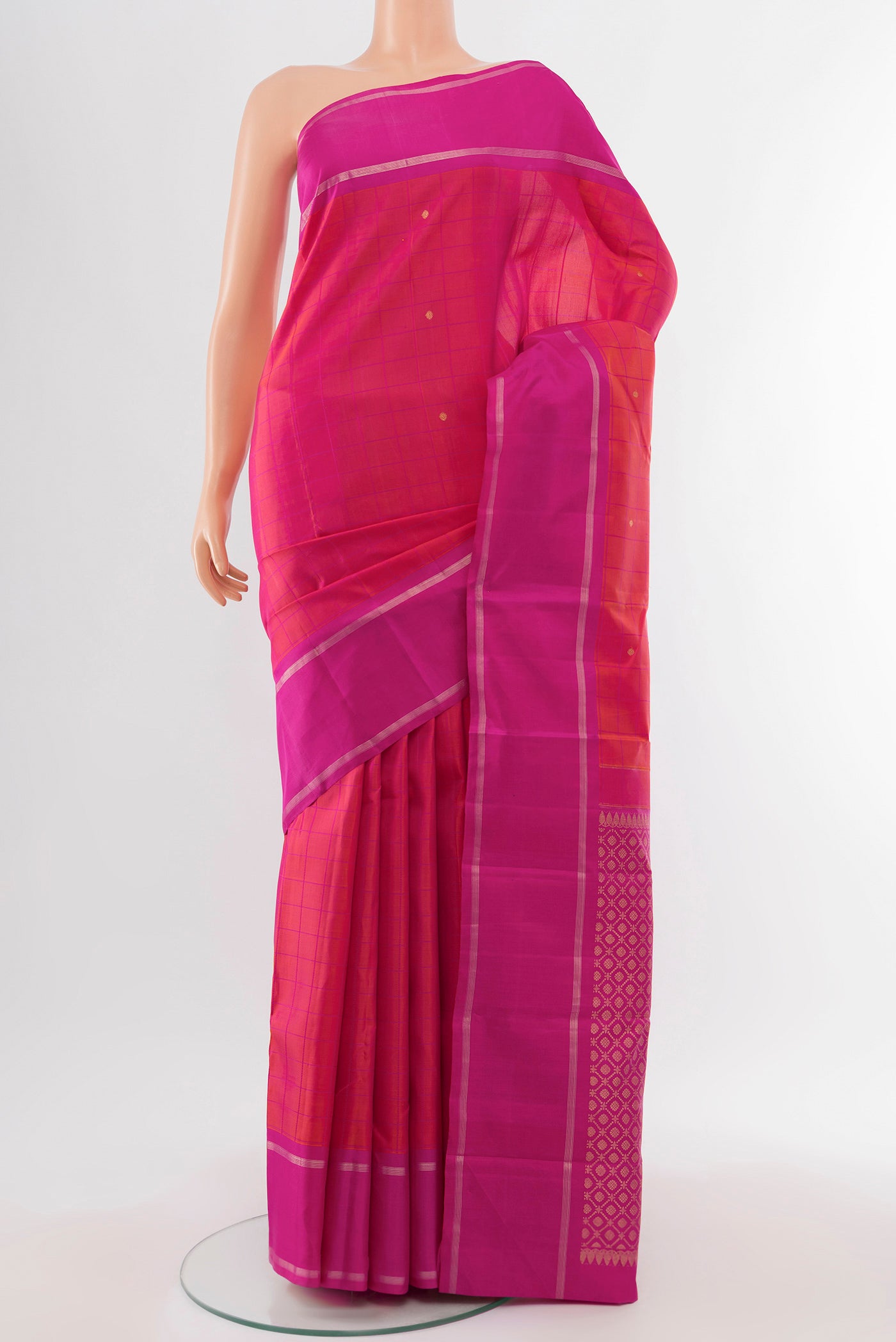 Pure Silk Pure Zari Peach Kanchipuram Saree with Zari Butta on the body and Silk Border.  displayed on a mannequin