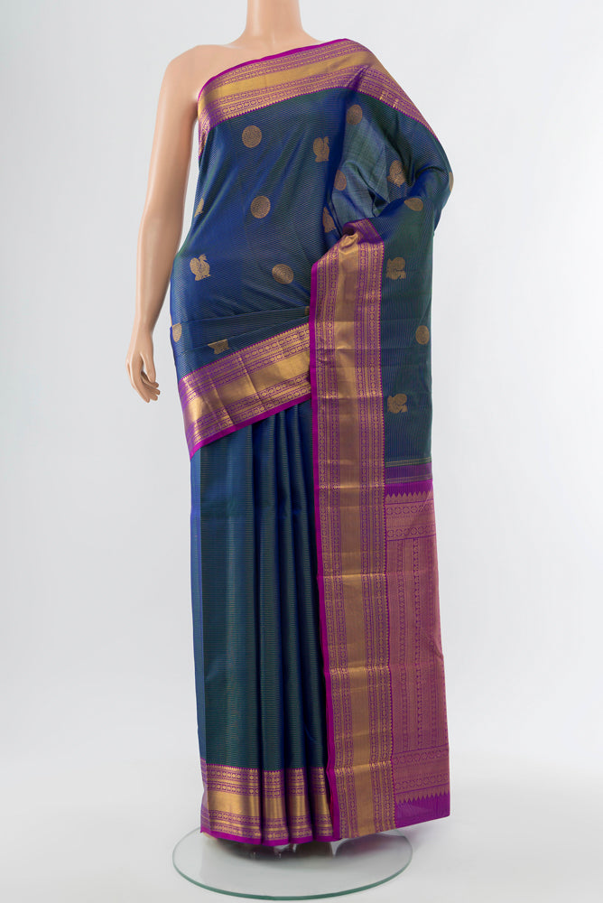 Navy Blue Kanjivaram Silk Saree with Zari Butta on the body and Silk Border.  displayed on a mannequin