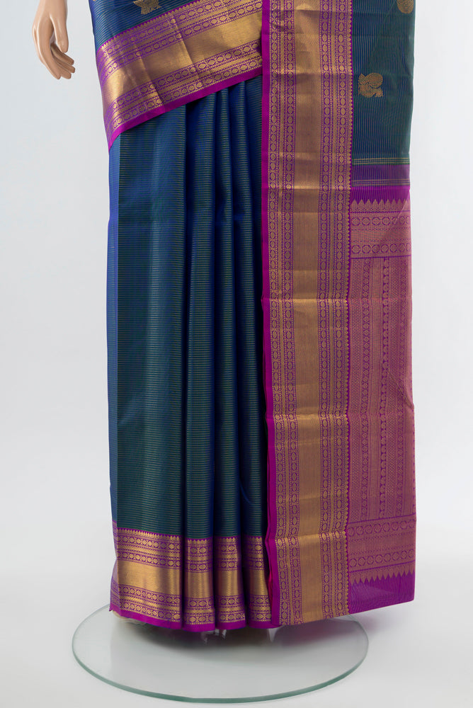 Pleats and pallu of Navy Blue Kanjivaram Silk Saree with Zari Butta on the body and Silk Border. 