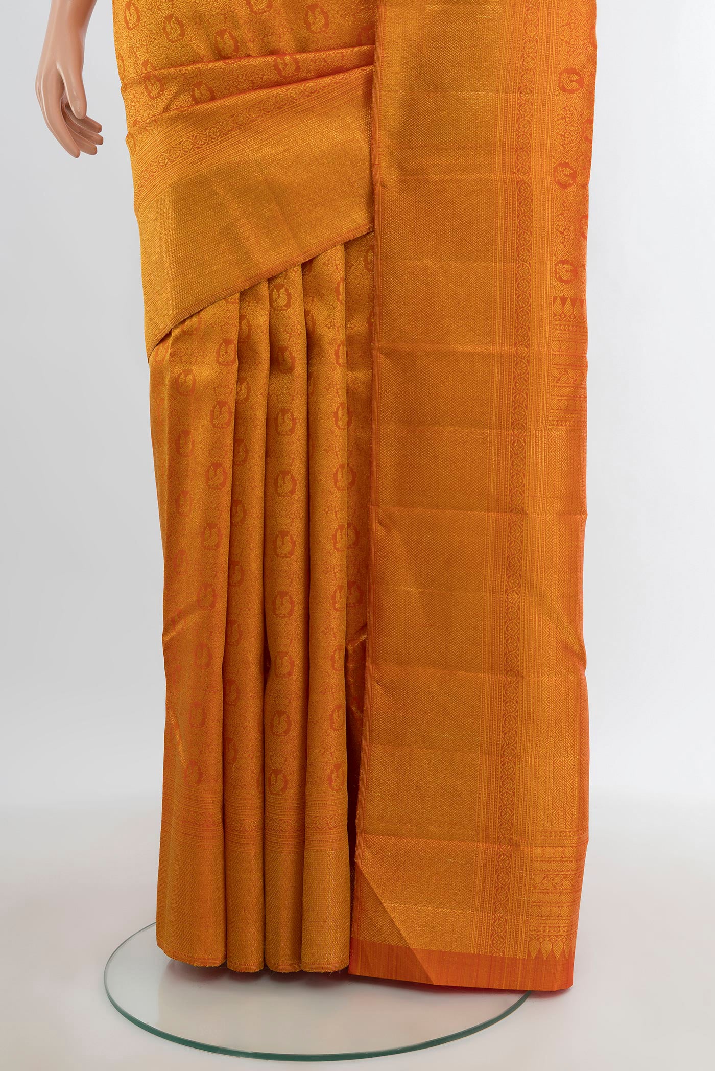 Pleats and pallu of Brick Orange Kanchipuram Silk Saree with Zari Brocade on the body and Zari Border. 