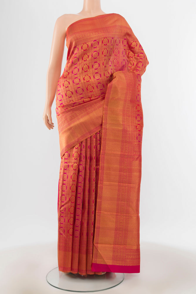 Peach Kanchipuram Silk Saree with Zari Brocade on the body and Silk Border.  displayed on a mannequin
