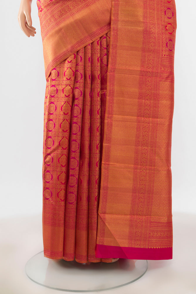 Pleats and pallu of Peach Kanchipuram Silk Saree with Zari Brocade on the body and Silk Border. 