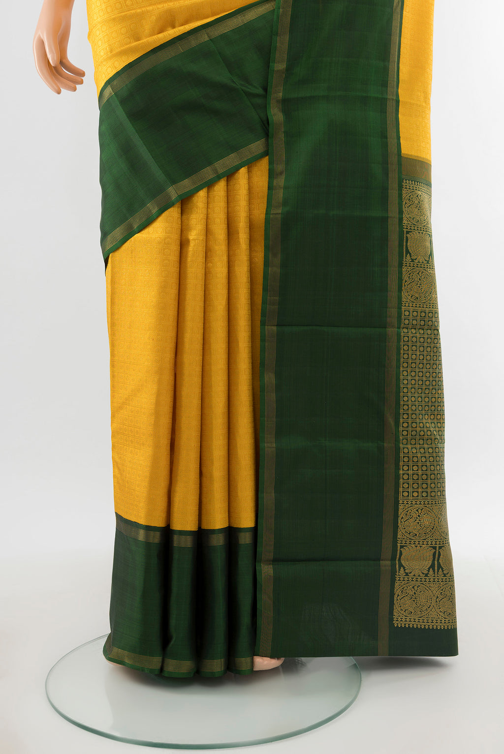 Pleats and pallu of Pure Silk Pure Zari Yellow Kanchipuram Saree with Zari Butta on the body and Silk Border. 