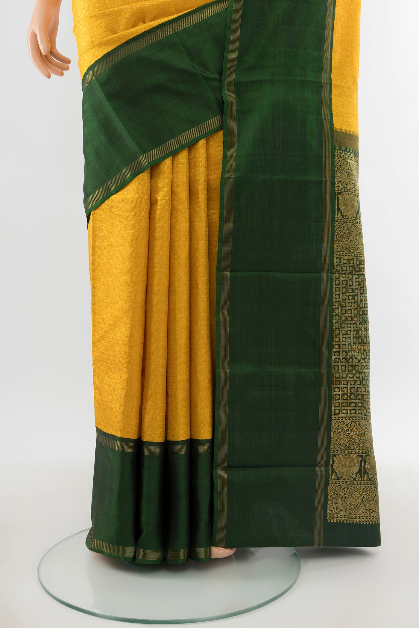 Pleats and pallu of Pure Silk Pure Zari Yellow Kanchipuram Saree with Zari Butta on the body and Silk Border. 