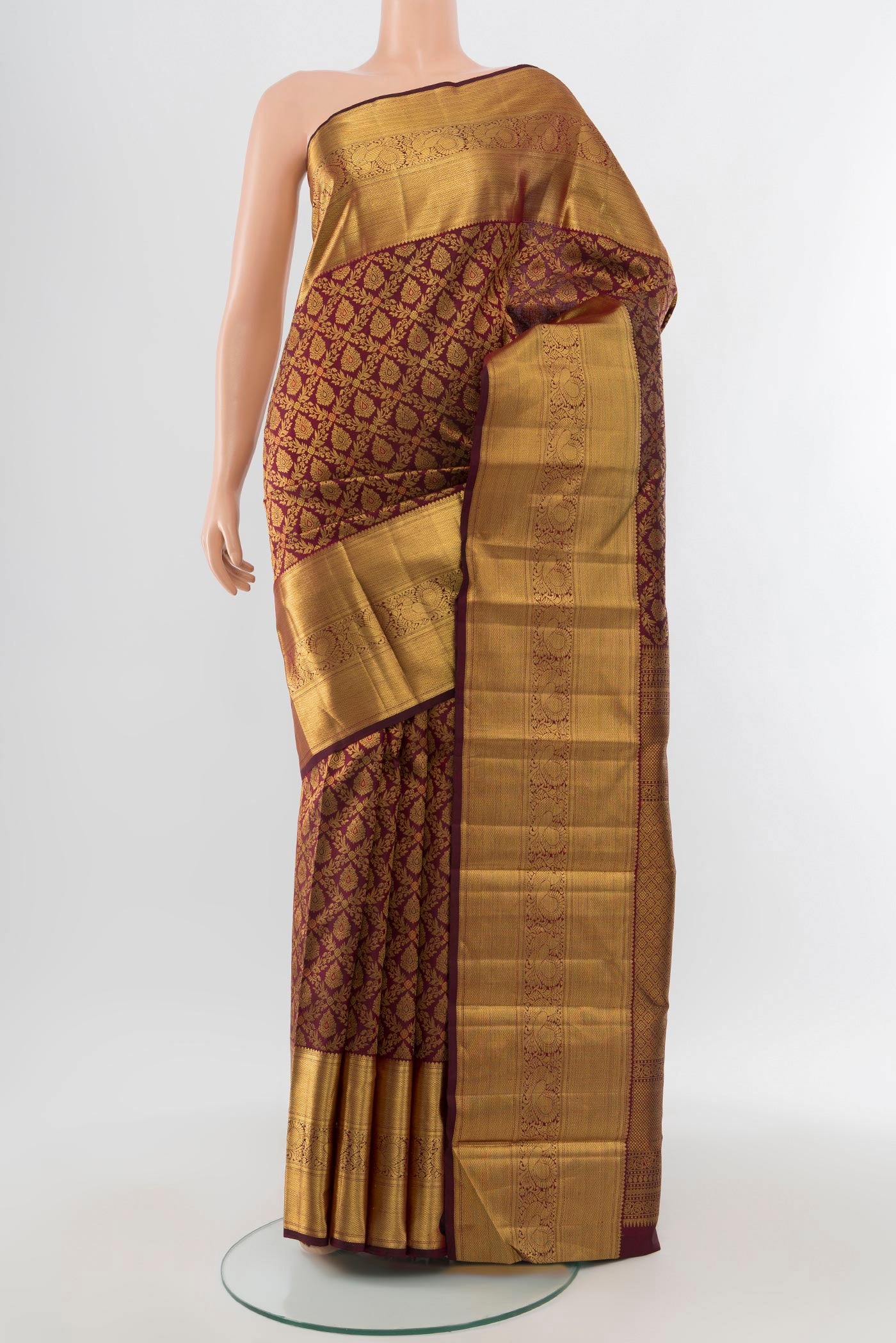 Pure Silk Pure Zari Maroon Kanchipuram Saree with Zari Butta on the body and Silk Border.  displayed on a mannequin