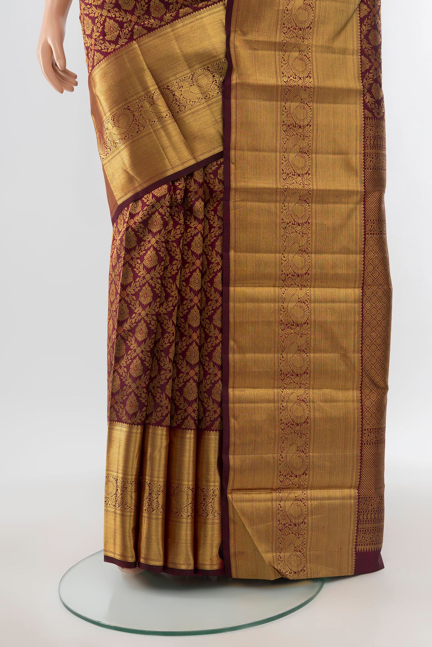 Pleats and pallu of Pure Silk Pure Zari Maroon Kanchipuram Saree with Zari Butta on the body and Silk Border. 
