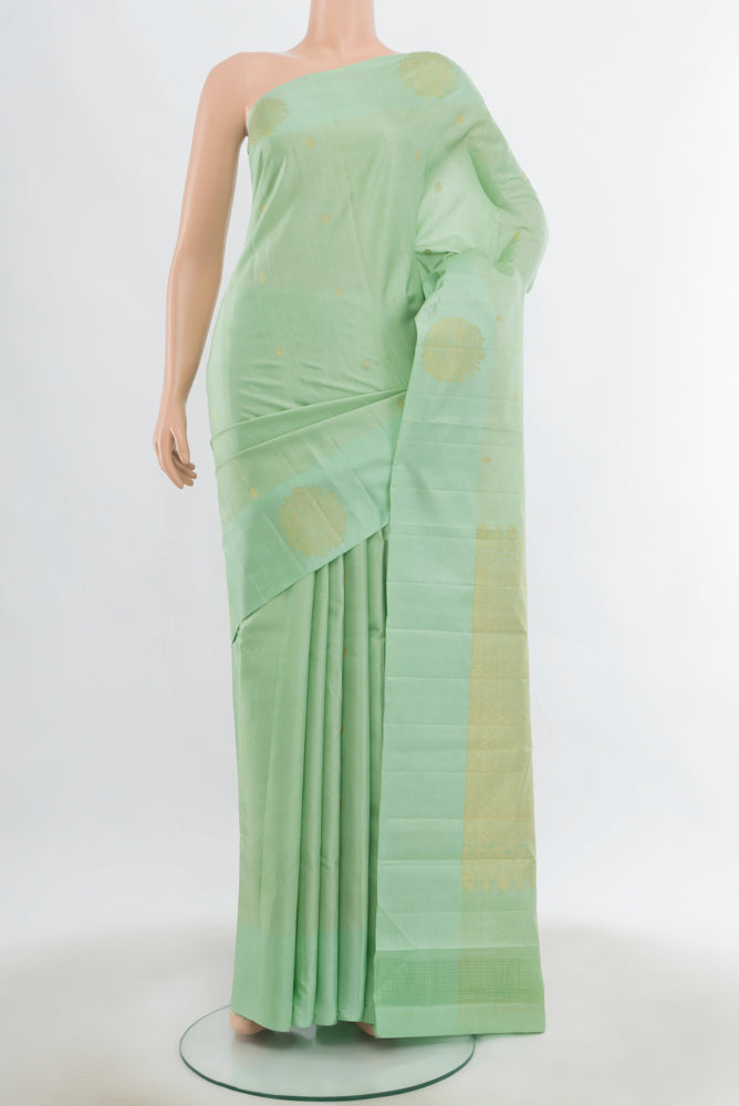 Pista Green Kanchipuram Silk Saree with Zari Butta on the body and Fancy Border.  displayed on a mannequin
