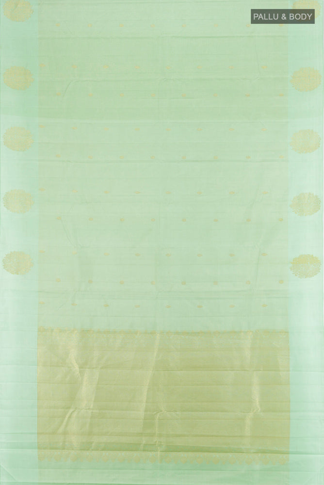 Flat view of Pista Green Kanchipuram Silk Saree with Zari Butta on the body and Fancy Border. 