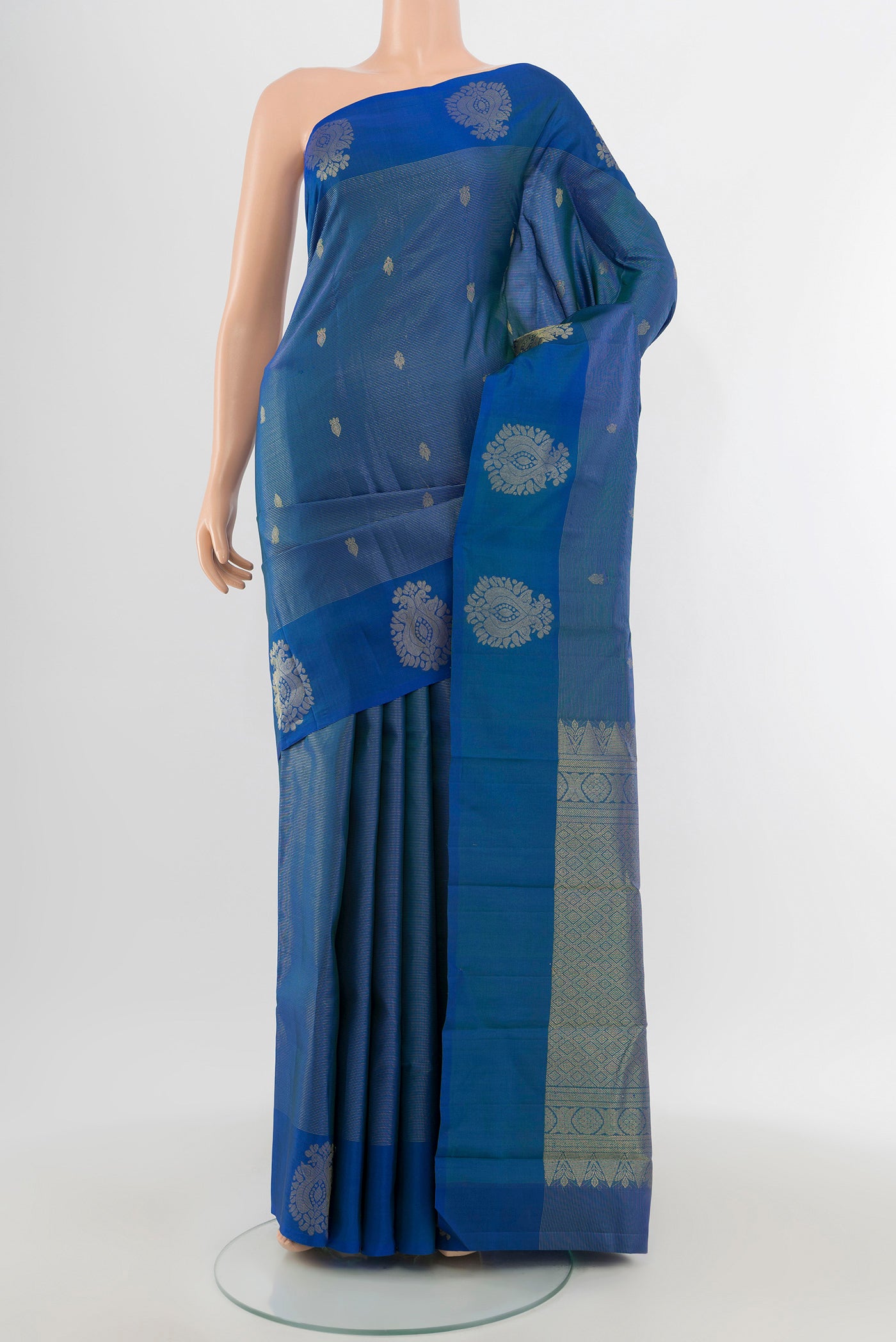 Blue Kanchipuram Silk Saree with Zari Butta on the body and Zari Border.  displayed on a mannequin