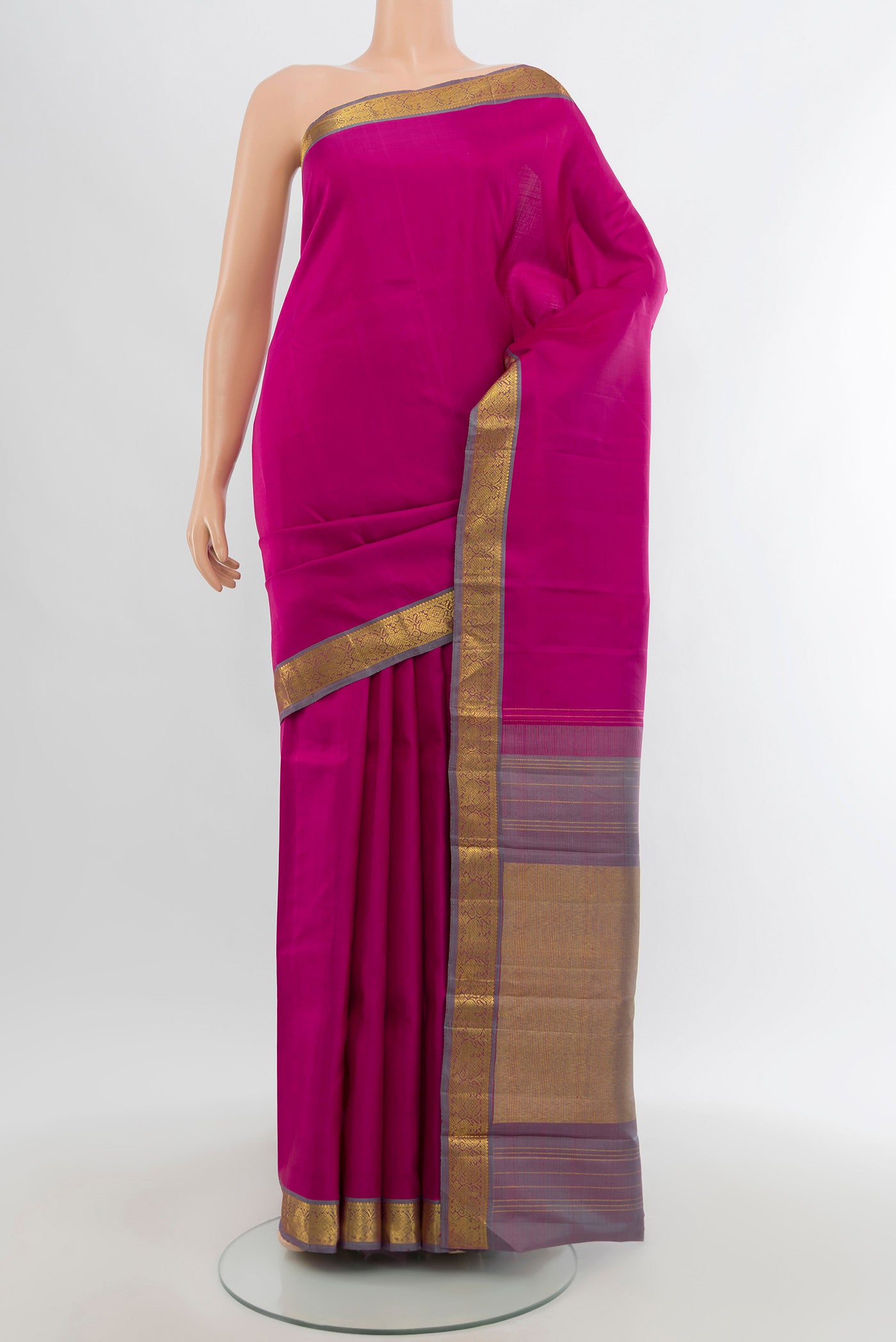 Rani Pink Kanchipuram Silk Saree with Zari Butta on the body and Zari Border.  displayed on a mannequin