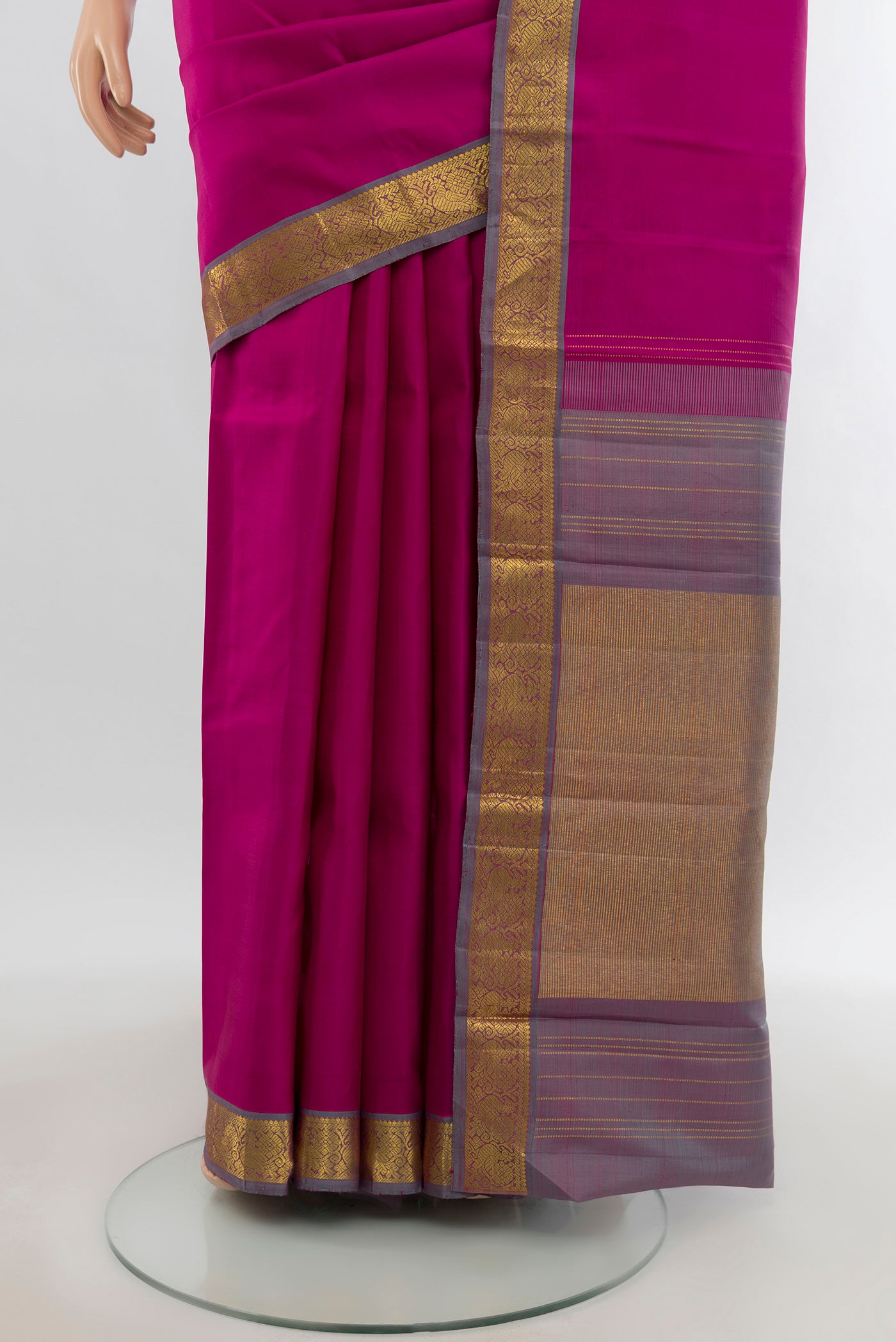Pleats and pallu of Rani Pink Kanchipuram Silk Saree with Zari Butta on the body and Zari Border. 