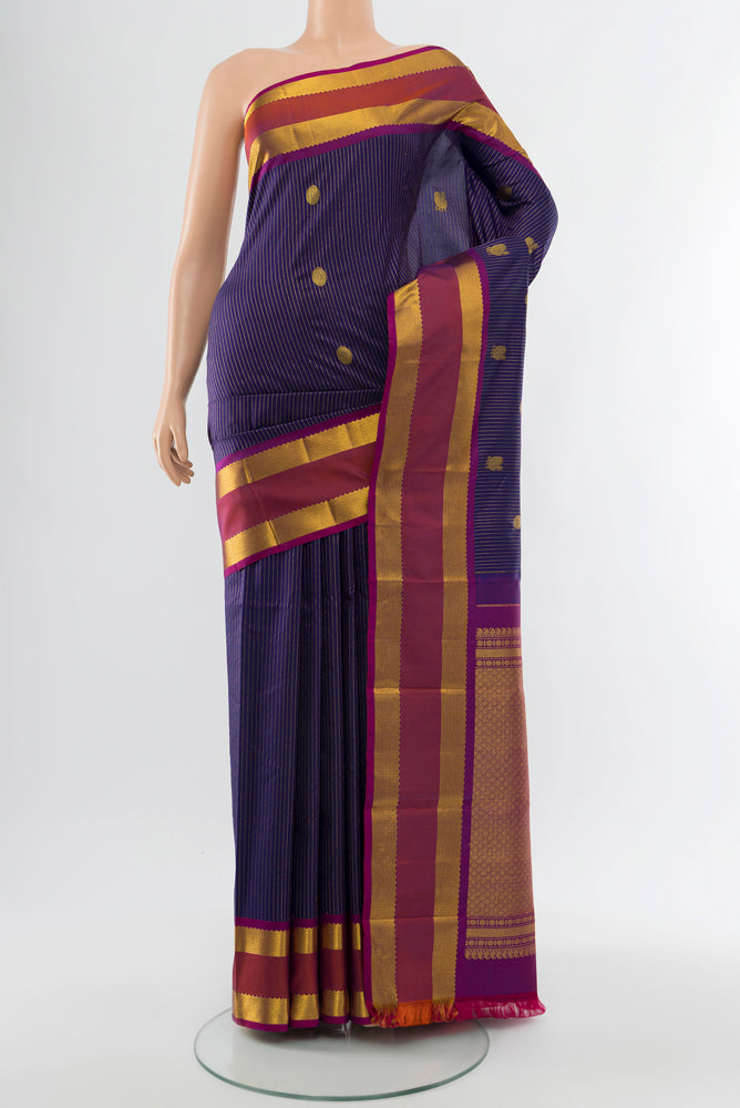 Navy Blue Kanjivaram Silk Saree with Zari Butta on the body and Silk Border.  displayed on a mannequin